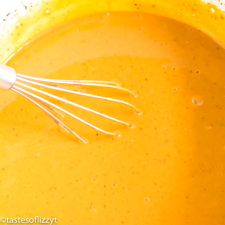 mustard bbq sauce in a pan with whisk