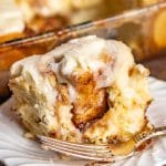 cinnamon roll on a plate with a bite out