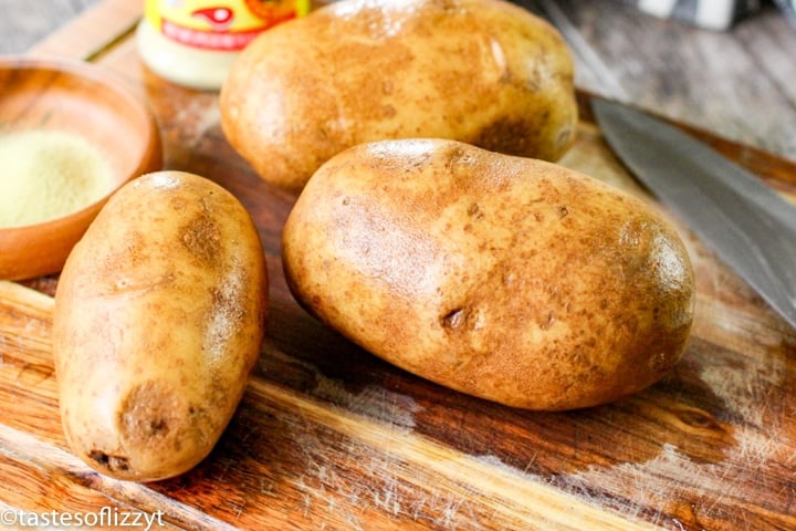 russet potatoes on a cutting board