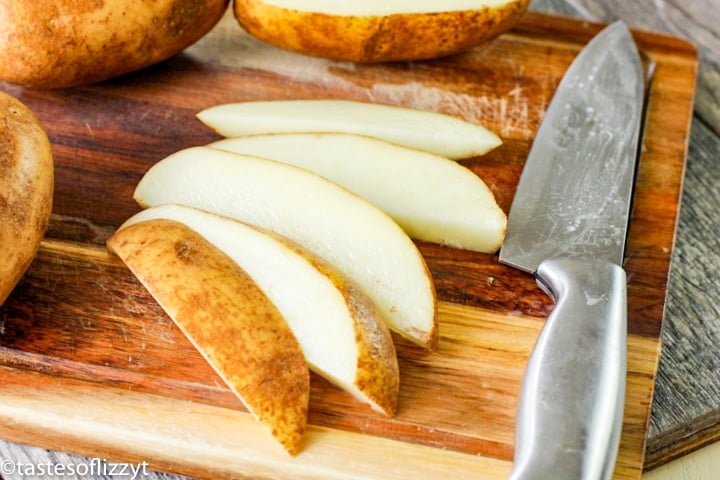 potato wedges on a cutting board