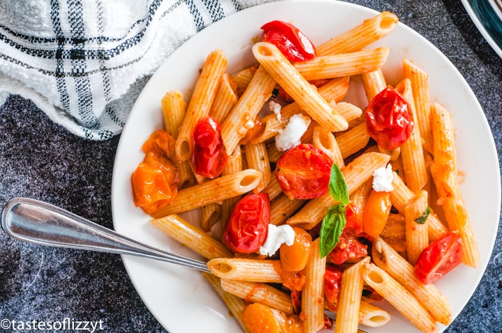 A plate of food on a table, with Pasta and Tomato