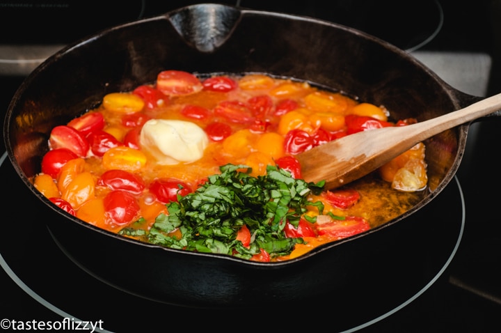 tomatoes, butter and basil in a skillet