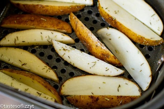 A sliced banana on a plate, with Potato wedges