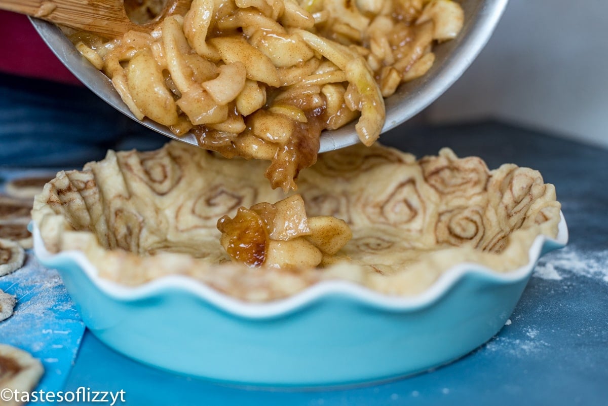 pouring apples into a pie plate