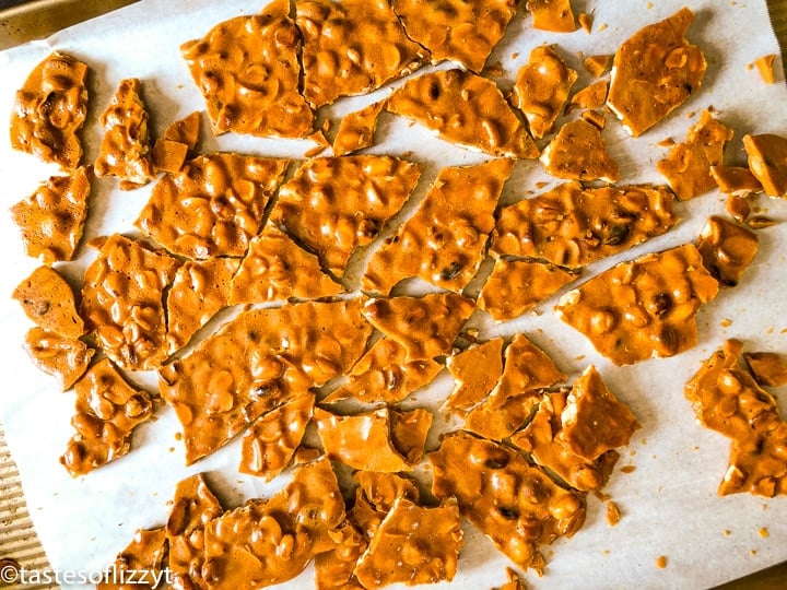 pieces of peanut brittle on parchment paper