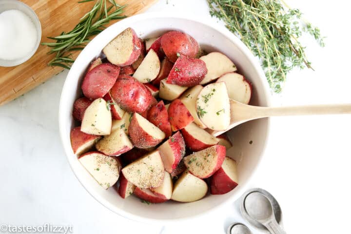 raw potatoes in a bowl with seasoning