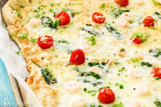 A pizza covered in cheese and tomatoes