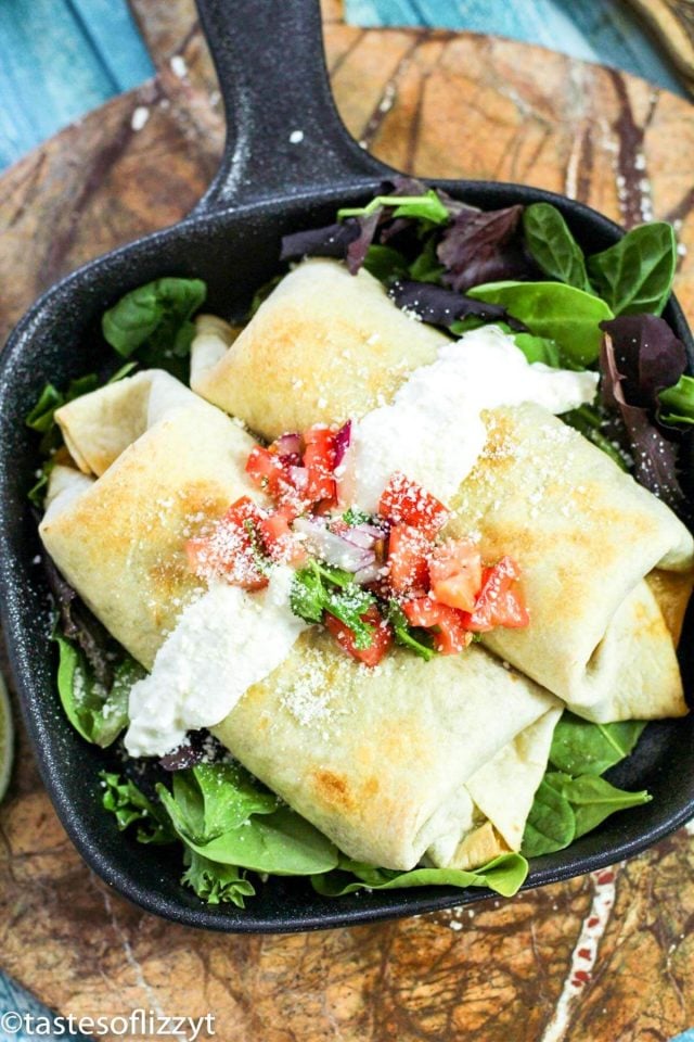 A plate of food, with baked chicken chimichangas