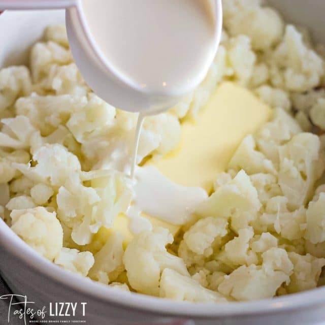 pouring milk over butter and cauliflower