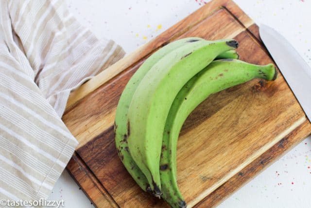 green plantains on a cutting board