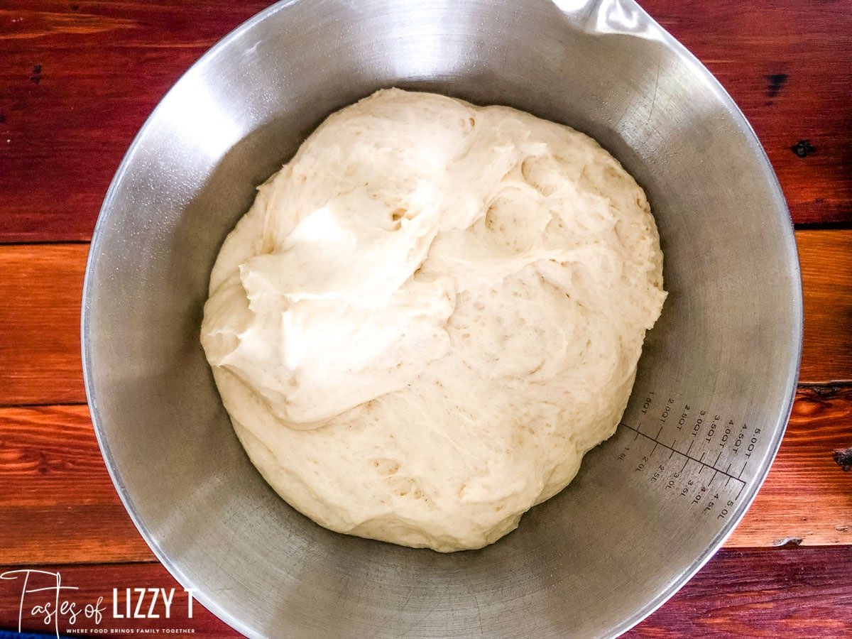 cinnamon roll dough rising in a bowl