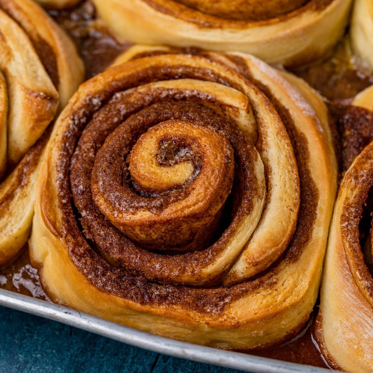 extra large cinnamon roll in a baking pan