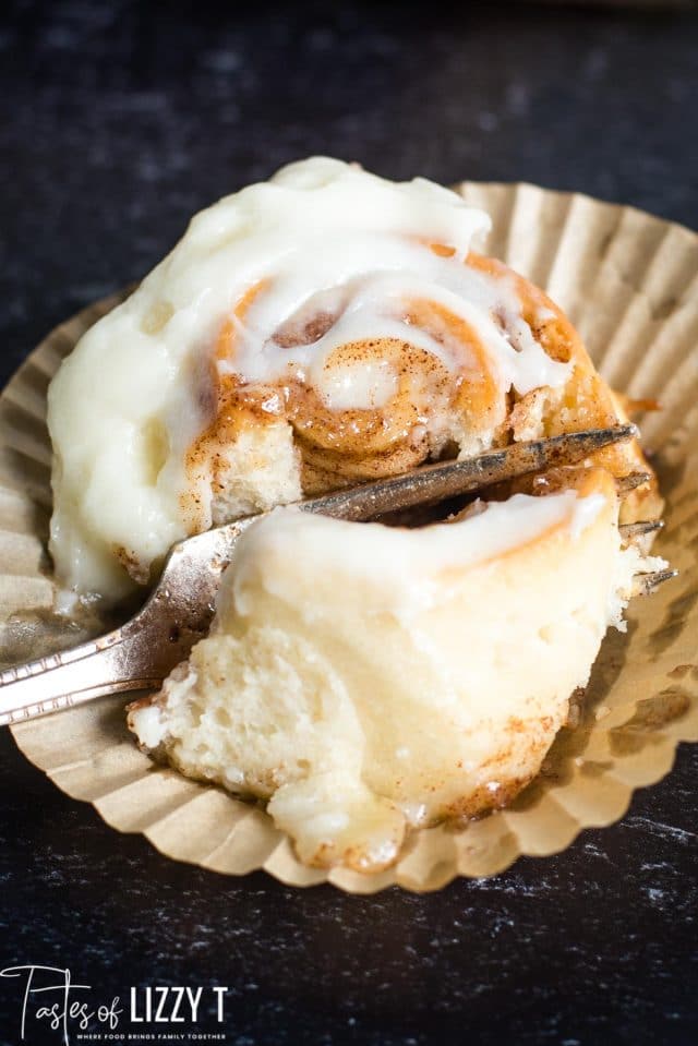 fork cutting a cinnamon roll