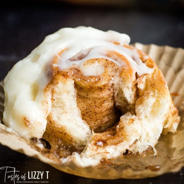 A close up of a cinnamon roll with a bite out