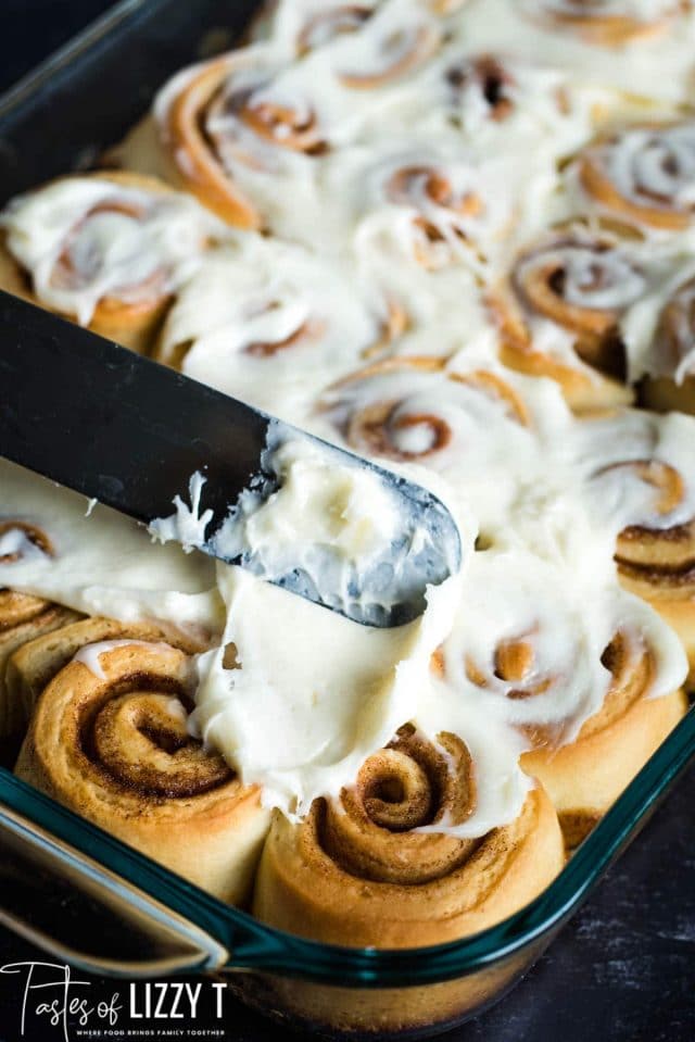 spreading frosting on mini cinnamon rolls