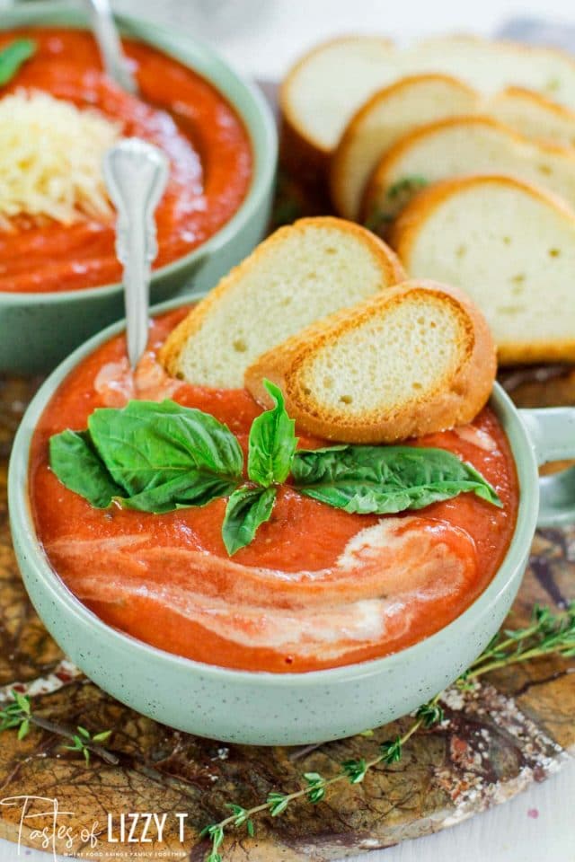 A plate of food, with tomato soup and bread