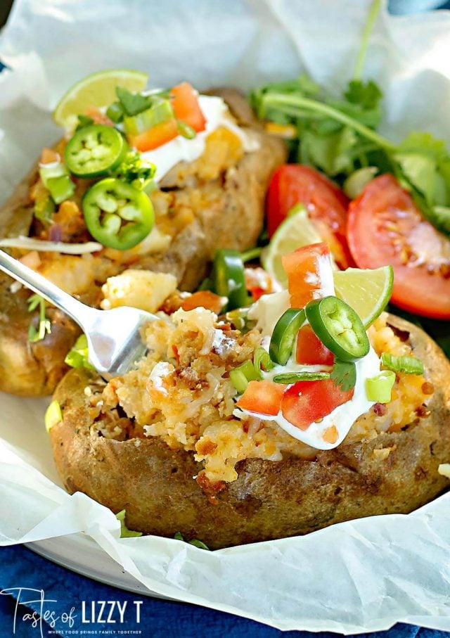 A close up of food on a table, with Baked potato