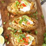 3 Mexican Twice Baked Potatoes on a cutting board