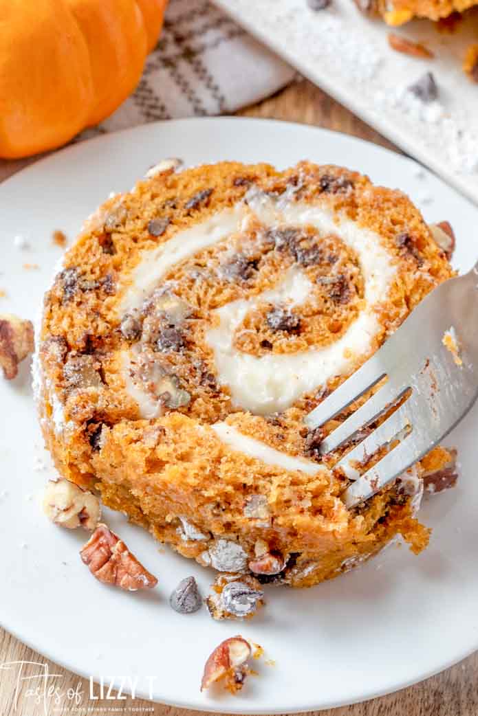 slices of pumpkin roll on a plate with a fork