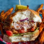 Fried Pork Tenderloin Sandwich in a basket with fries