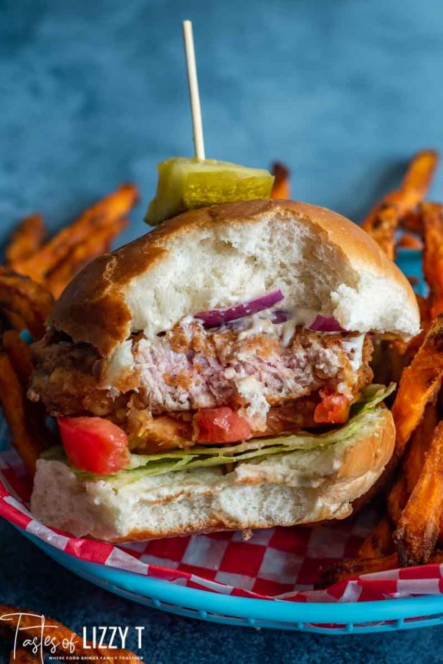 A pork tenderloin sandwich with a bite out