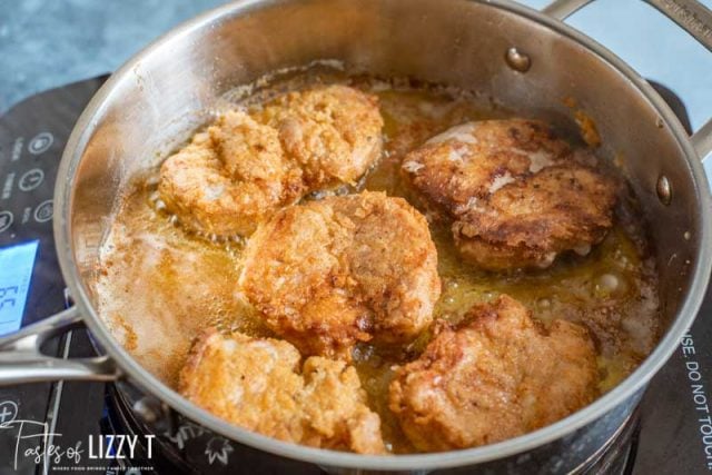 fried pork tenderloin in a skillet