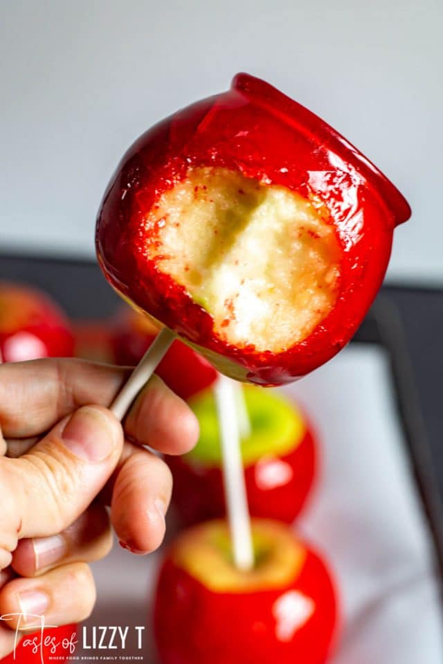 A close up of a candied apple with bite out