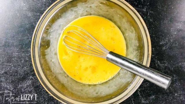 mixing eggs in a bowl with a whisk