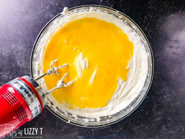 mixing eggs into cheescake batter