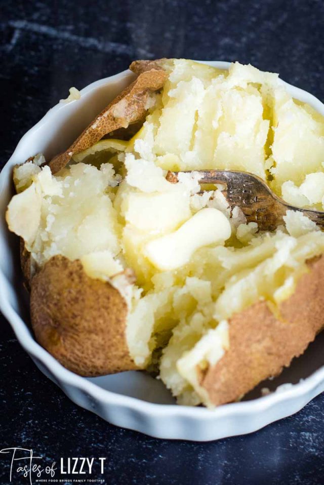 baked potato with butter and fork