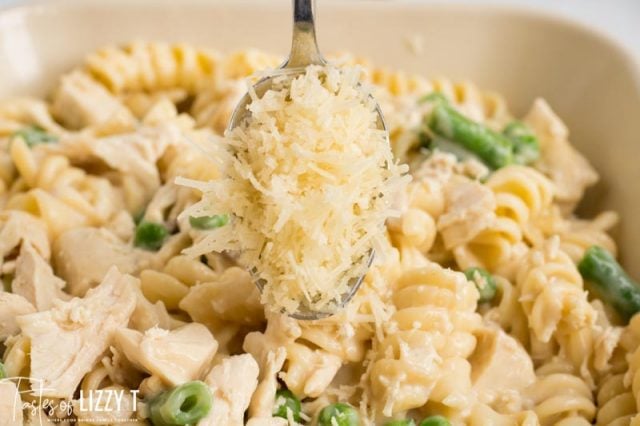 sprinkling parmesan cheese over casserole