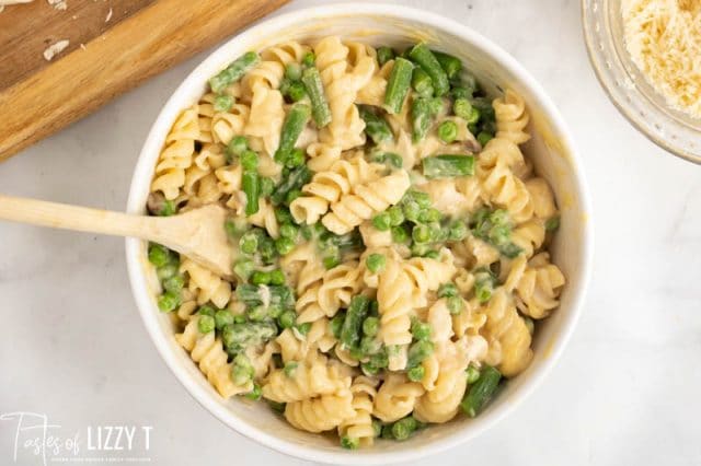 A bowl of food  with noodles, vegetables and turkey