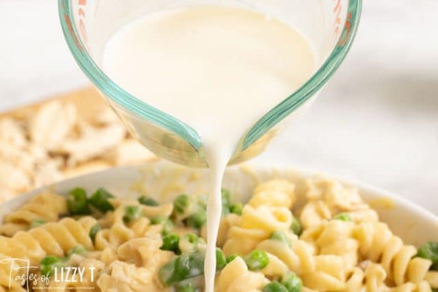 pouring milk over casserole