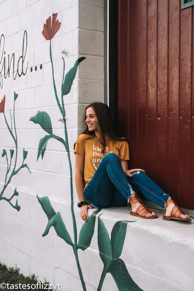 A woman sitting in on a wall