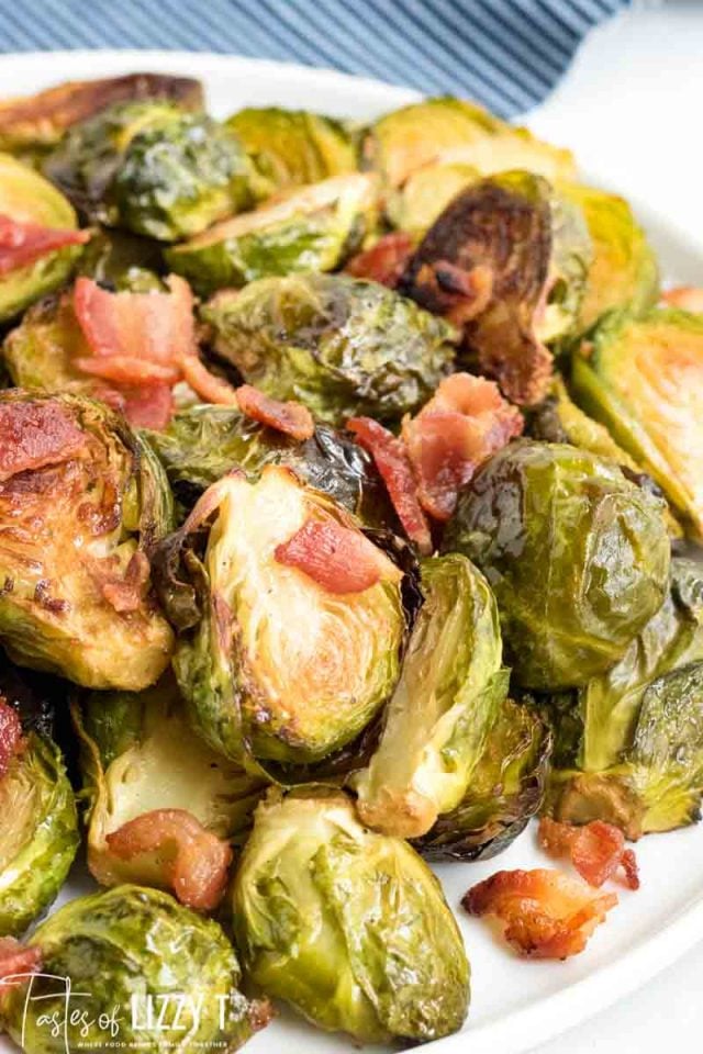 A plate of food, with Bacon and Brussels sprout