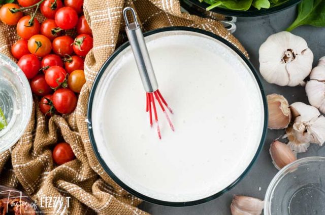 a bowl of white sauce in a dish