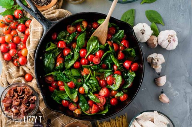 lettuce and tomatoes in a skillet