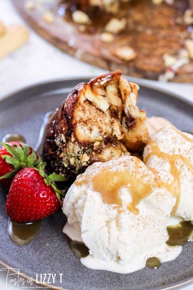 A close up of a piece of monkey bread and ice cream on a plate