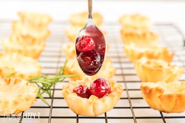 spooning cranberries into pastry shell