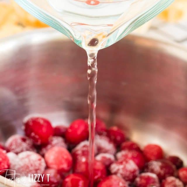 pouring water over cranberries