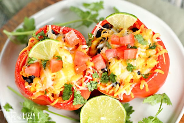 A bowl of salad on a plate, with Stuffed peppers and Taco toppings