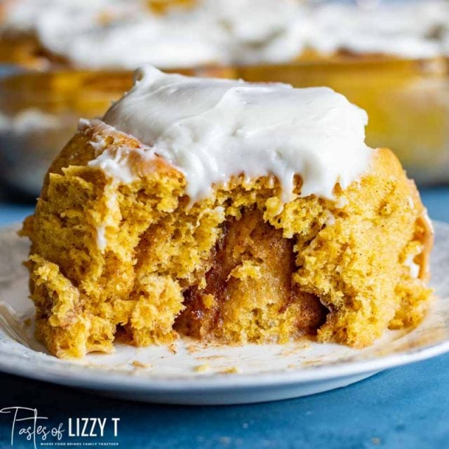 cinnamon roll on a plate with a bite out