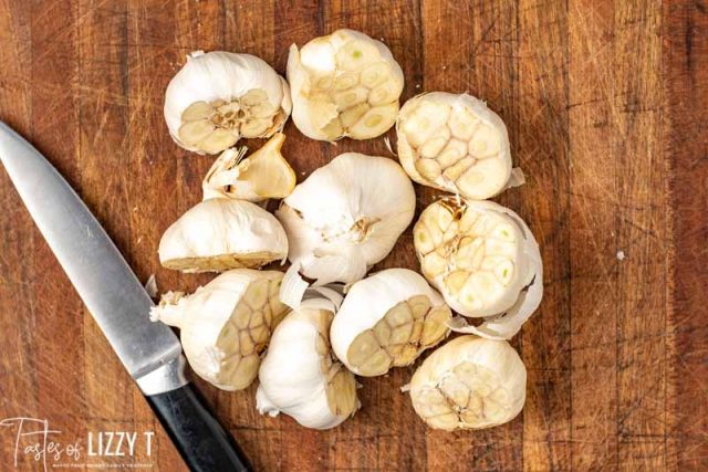 A wooden cutting board, with Garlic