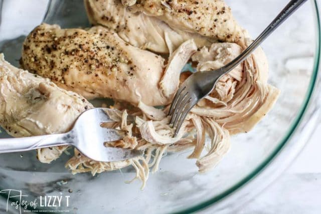 chicken in a bowl with two forks