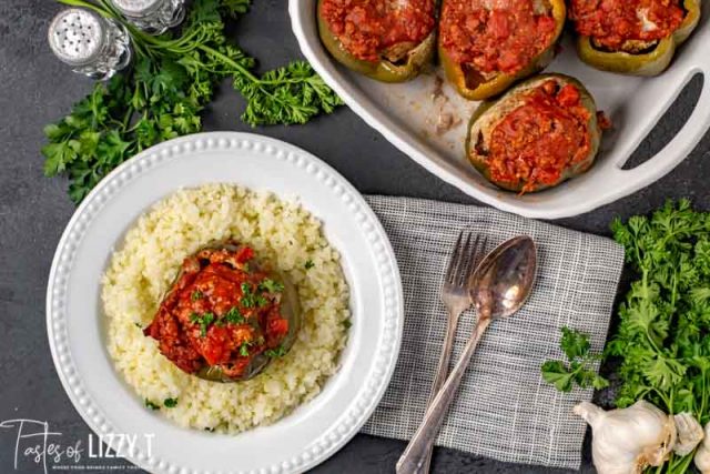 A bowl of food on a plate, with Stuffed peppers and Rice