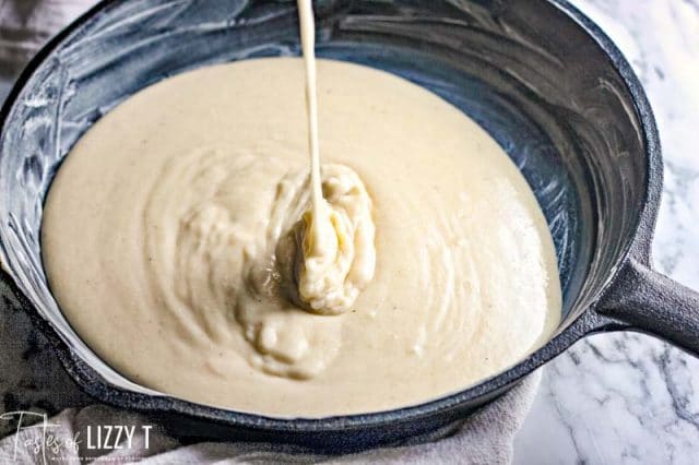 cornbread batter pouring into skillet