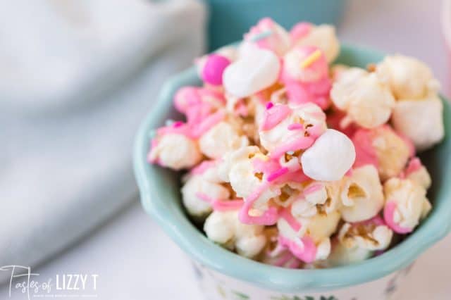A close up of a bowl of food, with Popcorn and Candy