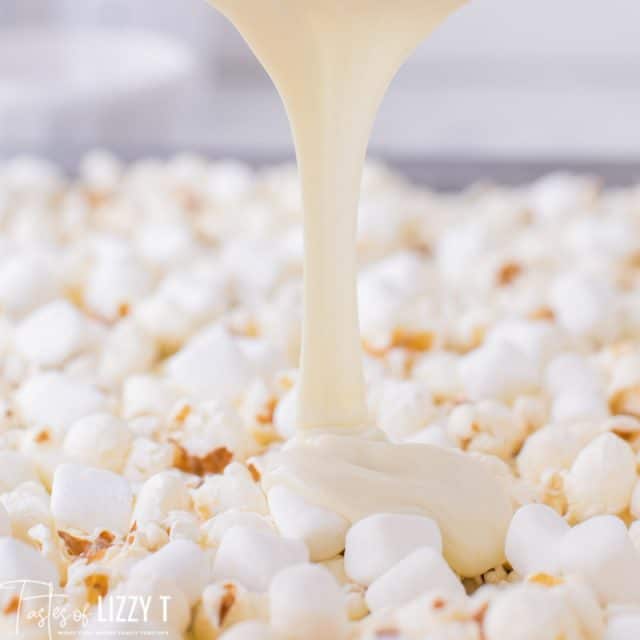 melted white chocolate pouring over popcorn