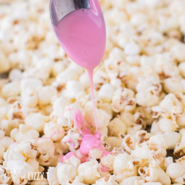 melted pink candy over popcorn
