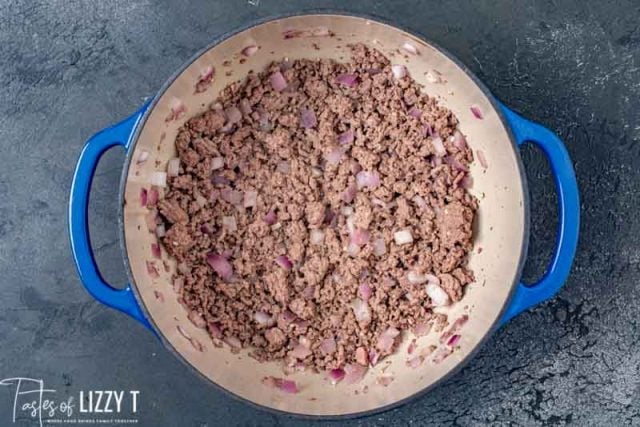 browned beef and onions in a dutch oven